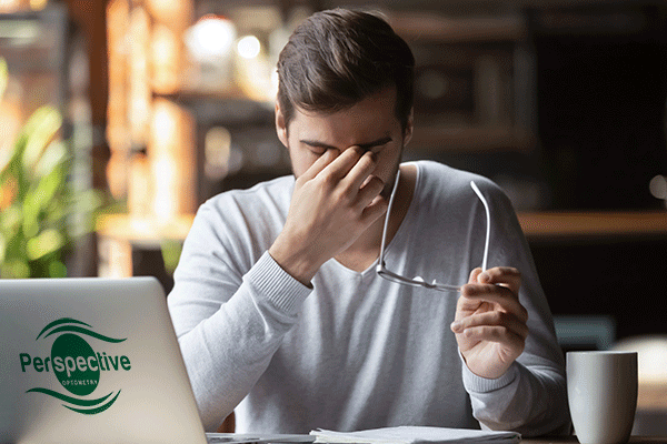 Computer Vision Syndrome - man at his laptop rubbing his tired eyes